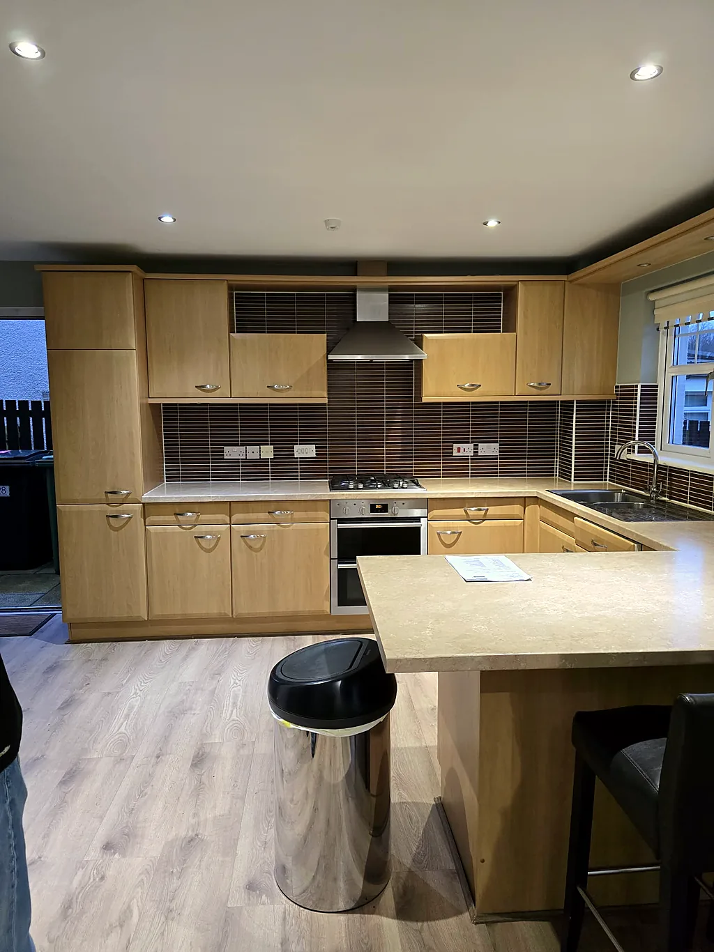 Dated oak kitchen with peninsula before the refit