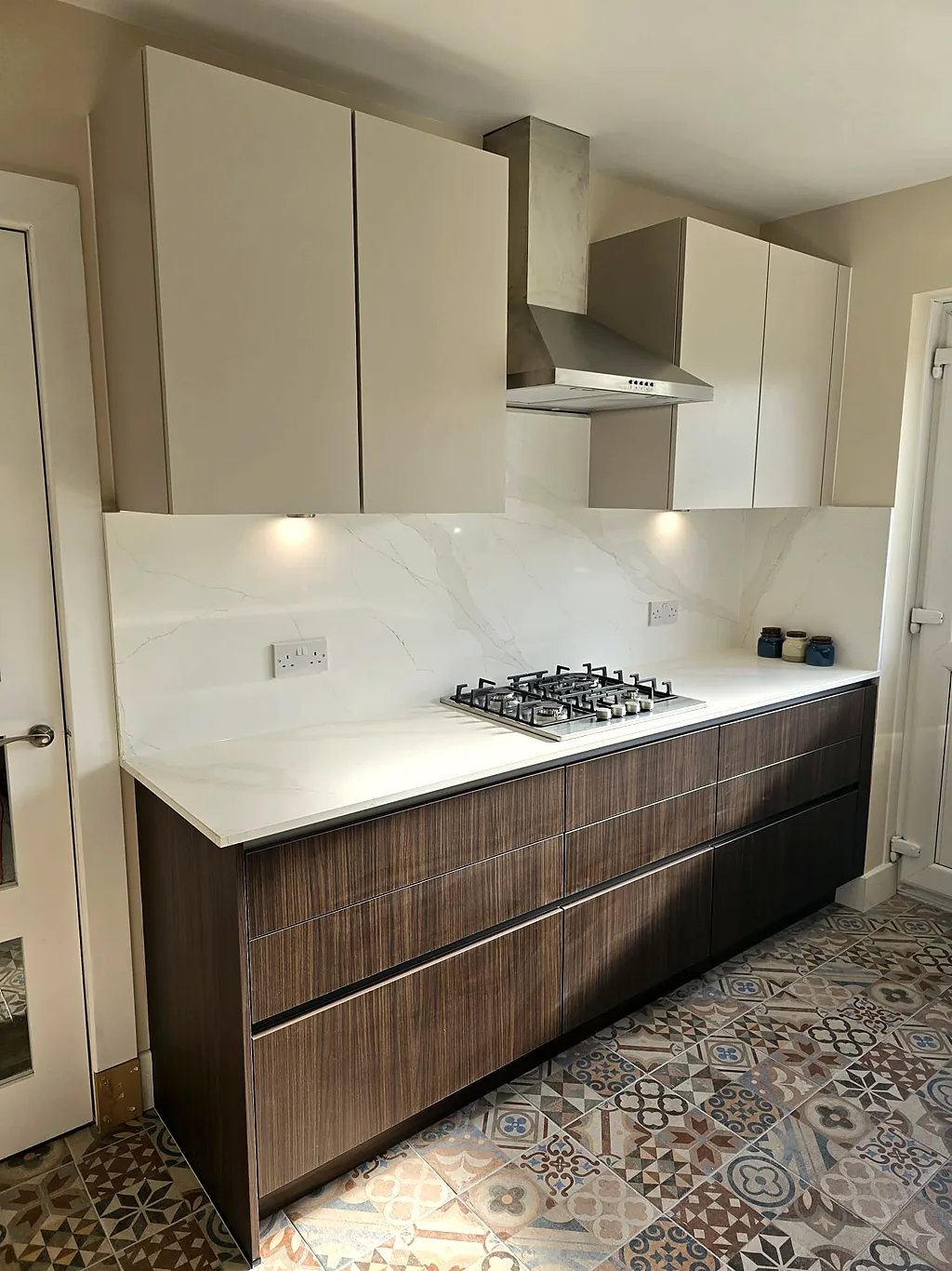 Walnut kitchen with marble worktop and gas hob after renovation
