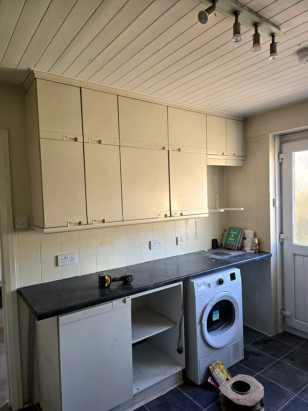 Dated cream kitchen mid strip-out before the refit