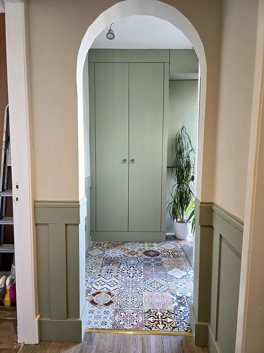 Bespoke fitted wardrobe under an arched recess